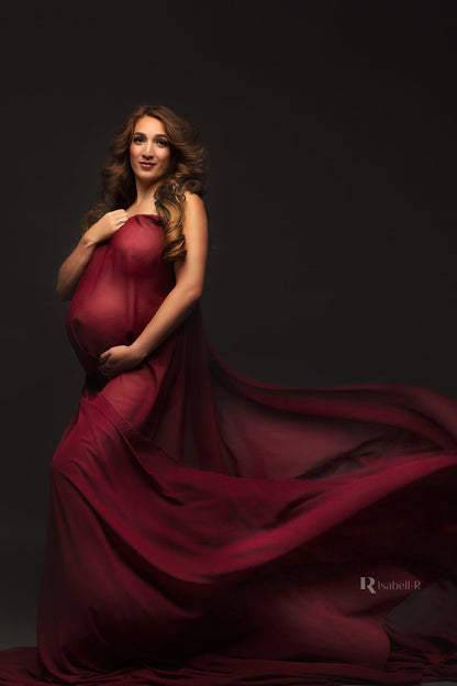 Model wearing a scarf around her body as a dress. The scarf is bordeaux red 