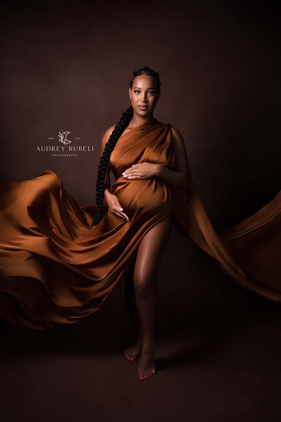 model poses in a studio with a scarf styled like a dress with enough flowing material for the close up. 